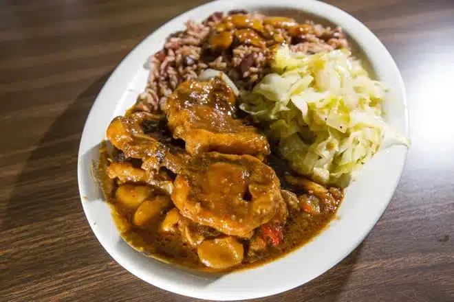 Jamaican Oxtail Stew Served With Caribbean Rice, Beans, Cabbage, and Onions in Berrien Springs